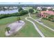 Scenic view of the golf course featuring a sand trap, manicured greens, and surrounding homes near the lake at 10256 Shadow Run Ct, Punta Gorda, FL 33955