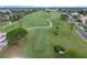 Lush green golf course with well-maintained fairways, mature trees, and glimpses of the surrounding residential area at 10256 Shadow Run Ct, Punta Gorda, FL 33955