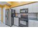 Modern kitchen with stainless steel refrigerator and oven with white cabinetry at 10256 Shadow Run Ct, Punta Gorda, FL 33955