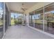 Covered lanai with a ceiling fan, offering serene outdoor views at 10256 Shadow Run Ct, Punta Gorda, FL 33955