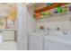 Functional laundry room adjacent to the kitchen with washer and dryer at 10256 Shadow Run Ct, Punta Gorda, FL 33955