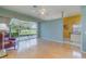 Bright living room with a ceiling fan, hardwood flooring, and a large sliding glass doors to the lanai at 10256 Shadow Run Ct, Punta Gorda, FL 33955
