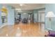 Open-concept living room with hardwood floors, a ceiling fan, and adjacent dining area at 10256 Shadow Run Ct, Punta Gorda, FL 33955