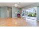 Spacious living room with hardwood flooring, a ceiling fan, and large sliding glass doors to the lanai at 10256 Shadow Run Ct, Punta Gorda, FL 33955