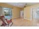 Spacious living room showcasing hardwood floors, ceiling fan, and outdoor access at 10256 Shadow Run Ct, Punta Gorda, FL 33955
