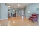 Large, airy living room with hardwood floors, a ceiling fan, and adjacent dining area at 10256 Shadow Run Ct, Punta Gorda, FL 33955