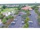 Parking area surrounded by palm trees, near a clubhouse and golf course at 10256 Shadow Run Ct, Punta Gorda, FL 33955