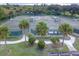 Aerial view of well-maintained tennis courts surrounded by lush greenery and manicured landscaping at 10256 Shadow Run Ct, Punta Gorda, FL 33955