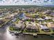 Aerial view of waterfront homes in a tropical community featuring canals, lush landscaping and private boat docks under a sunny sky at 1217 Bobwhite Court, Punta Gorda, FL 33950
