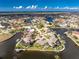 Waterfront living captured in this aerial, featuring seawall, tropical landscaping, and easy access to the canals for boating at 1217 Bobwhite Court, Punta Gorda, FL 33950