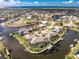 Beautiful aerial shot showcases waterfront home with boat dock, seawall, and tropical landscaping in a desirable coastal community at 1217 Bobwhite Court, Punta Gorda, FL 33950