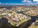 Panoramic aerial showing waterfront homes boasting private docks, seawalls, and tropical landscaping, perfect for boating enthusiasts at 1217 Bobwhite Court, Punta Gorda, FL 33950