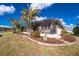 Home's backyard with screened-in porch and well-manicured landscaping at 1217 Bobwhite Court, Punta Gorda, FL 33950
