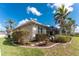 Exterior view of backyard landscaping with stepping stones and screened-in patio at 1217 Bobwhite Court, Punta Gorda, FL 33950