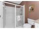 Bathroom with a large glass door shower, toilet and artwork at 1217 Bobwhite Court, Punta Gorda, FL 33950