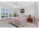 Bedroom with neutral decor, shutters, and ample natural light at 1217 Bobwhite Court, Punta Gorda, FL 33950