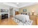 Bright bedroom with hardwood floors, artwork, and a ceiling fan for a comfortable living space at 1217 Bobwhite Court, Punta Gorda, FL 33950