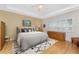 Cozy bedroom featuring hardwood floors, a ceiling fan, and natural light from the shuttered windows at 1217 Bobwhite Court, Punta Gorda, FL 33950