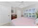 This cozy bedroom has natural light from the window and features a ceiling fan at 1217 Bobwhite Court, Punta Gorda, FL 33950