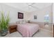 Cozy bedroom features a pink bedspread, neutral walls, and ceiling fan for added comfort at 1217 Bobwhite Court, Punta Gorda, FL 33950