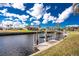 Peaceful canal view highlighting a private boat dock with lift at 1217 Bobwhite Court, Punta Gorda, FL 33950