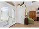 Foyer featuring a tile floor, double doors, an accent chair, and an elegant cabinet at 1217 Bobwhite Court, Punta Gorda, FL 33950