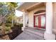 Charming front entrance featuring a double door with columns and landscaped garden at 1217 Bobwhite Court, Punta Gorda, FL 33950