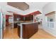 Modern kitchen featuring dark wood cabinets, granite countertops, and stainless steel appliances at 1217 Bobwhite Court, Punta Gorda, FL 33950