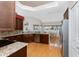 Well-equipped kitchen featuring stainless steel appliances, granite countertops, and wood flooring at 1217 Bobwhite Court, Punta Gorda, FL 33950