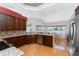 Bright and modern kitchen with stainless steel appliances, granite countertops, and wood flooring at 1217 Bobwhite Court, Punta Gorda, FL 33950