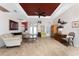 Spacious living room with elegant decor, comfortable seating, and a striking red ceiling accent at 1217 Bobwhite Court, Punta Gorda, FL 33950