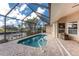 Gorgeous screened-in pool with a beautiful view of the canal and tropical landscaping at 1217 Bobwhite Court, Punta Gorda, FL 33950