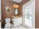 Powder room with single vanity, white sink and door leading to the outside at 1217 Bobwhite Court, Punta Gorda, FL 33950