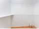 Empty white walk-in closet featuring metal shelving and hardwood floors at 1217 Bobwhite Court, Punta Gorda, FL 33950