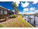 Waterfront backyard with lush grass and private boat lift system at 1217 Bobwhite Court, Punta Gorda, FL 33950