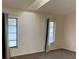 The bedroom offers natural light through two windows and features neutral carpeting at 20408 Andover Ave, Port Charlotte, FL 33954
