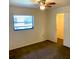 Carpeted bedroom with a ceiling fan, window, and closet for storage at 20408 Andover Ave, Port Charlotte, FL 33954