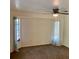 Cozy bedroom featuring a ceiling fan and bright windows adorned with curtains at 20408 Andover Ave, Port Charlotte, FL 33954