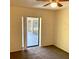 Bedroom with a ceiling fan and glass sliding doors leading to the outside at 20408 Andover Ave, Port Charlotte, FL 33954