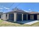 Exterior view of the house showing the screened lanai and neutral color scheme at 20408 Andover Ave, Port Charlotte, FL 33954