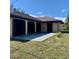 Rear exterior of home with enclosed lanai, neutral color scheme, and well-maintained lawn at 20408 Andover Ave, Port Charlotte, FL 33954