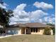 Charming single-story home with an attached garage, arched entry and windows, and well maintained landscaping at 20408 Andover Ave, Port Charlotte, FL 33954