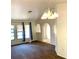 Spacious carpeted living room featuring archways, neutral tones, natural light, and decorative lighting at 20408 Andover Ave, Port Charlotte, FL 33954