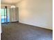 A spacious living room offers plenty of natural light with large windows and a sliding glass door at 20408 Andover Ave, Port Charlotte, FL 33954