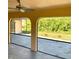 Inviting screened patio featuring a ceiling fan and views of the lush backyard at 20408 Andover Ave, Port Charlotte, FL 33954