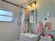 Well-lit bathroom with a shower, vanity, and modern fixtures at 21938 Catherine Ave, Port Charlotte, FL 33952