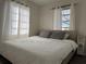 Bedroom featuring a large bed, comfortable gray pillows, and ample natural light at 21938 Catherine Ave, Port Charlotte, FL 33952