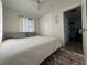Bright bedroom featuring a comfortable queen bed, closet, ceiling fan and window at 21938 Catherine Ave, Port Charlotte, FL 33952
