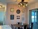 Bright dining area with unique decor, modern lighting, and view of the kitchen at 21938 Catherine Ave, Port Charlotte, FL 33952