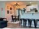 Bright dining area featuring modern light fixtures, decorative wall art, and a breakfast bar at 21938 Catherine Ave, Port Charlotte, FL 33952